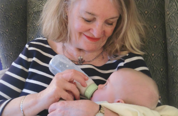 Mother-in-law Norah feeding our first child.