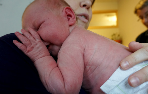 Amningsdagbok del två. Nyfödd bebis vilar mot sin mammas axel, sjukhusmiljö.